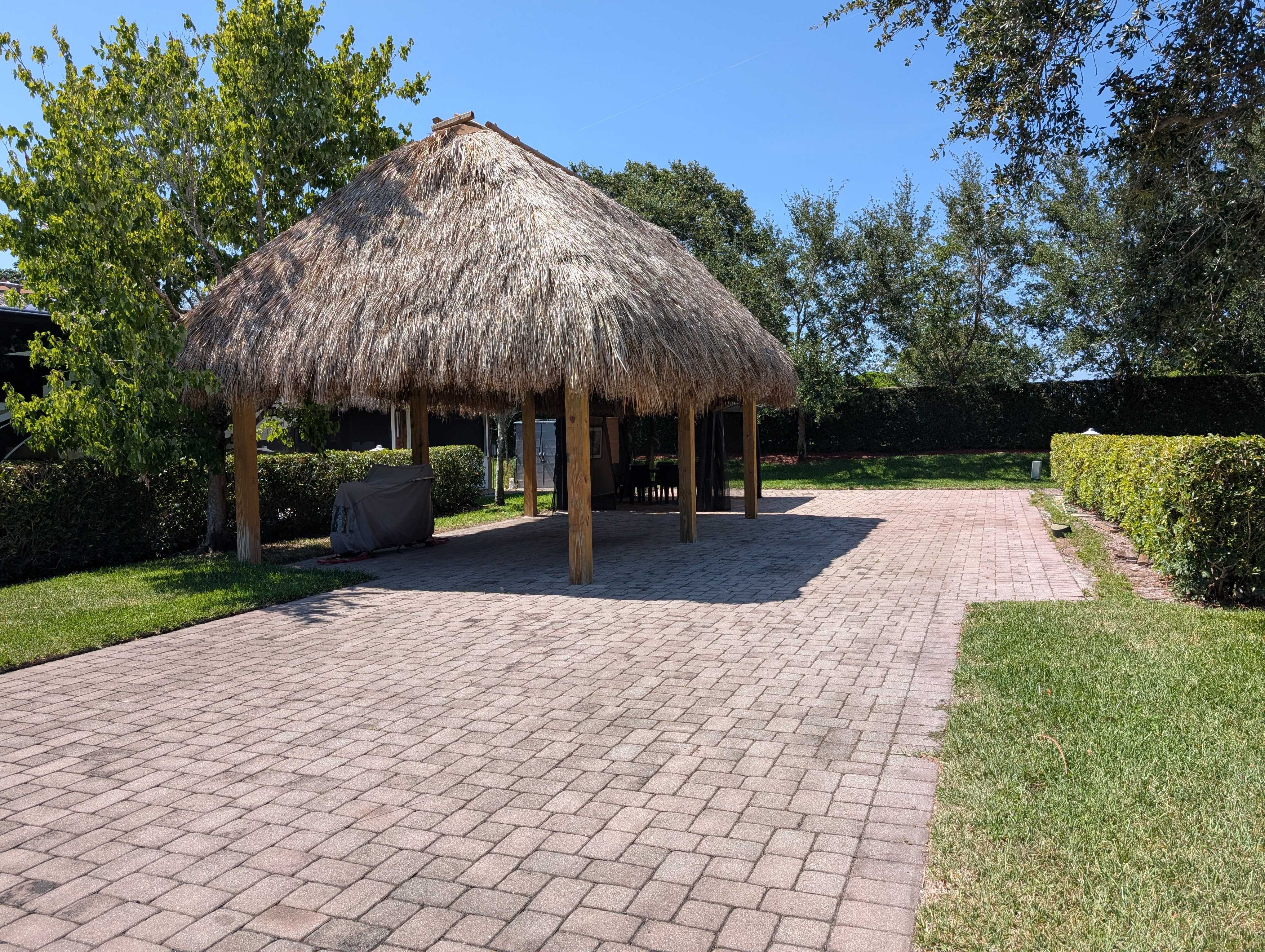 Paved RV pad and tiki hut exterior view